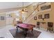 Bright living area showcasing a billiard table, tall ceilings, staircase and ample natural light at 425 Sterling Lake Dr, Ocoee, FL 34761