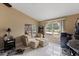 Main bedroom lounge area featuring a comfortable seating area and large windows with backyard views at 425 Sterling Lake Dr, Ocoee, FL 34761