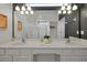 Bathroom with double sinks, large mirror, and walk-in shower visible at 4429 Ganesha Loop, Kissimmee, FL 34746
