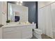 Clean bathroom with white vanity, toilet, mirror and shower/tub with white shower curtain at 4429 Ganesha Loop, Kissimmee, FL 34746