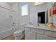 Bright bathroom with modern vanity, large mirror, and bathtub with shower at 4429 Ganesha Loop, Kissimmee, FL 34746