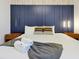 Comfortable bedroom featuring a navy headboard with stylish nightstands and linens at 4429 Ganesha Loop, Kissimmee, FL 34746