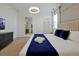 Stylish bedroom with modern lighting, TV, walk-in closet, and luxurious bed at 4429 Ganesha Loop, Kissimmee, FL 34746