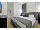 Elegant bedroom with a modern design and dark decor, including a comfortable bed and plush pillows at 4429 Ganesha Loop, Kissimmee, FL 34746