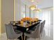 Formal dining room featuring stylish chandeliers, and an elegant table setting with gray chairs at 4429 Ganesha Loop, Kissimmee, FL 34746