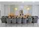 Formal dining room featuring stylish chandeliers, and an elegant table setting with gray chairs at 4429 Ganesha Loop, Kissimmee, FL 34746