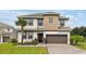 Beautiful two-story home features a well-manicured lawn, neutral color scheme, and attached two-car garage at 4429 Ganesha Loop, Kissimmee, FL 34746