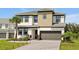 Charming two-story home showcasing lush landscaping, neutral color scheme, and a two-car garage at 4429 Ganesha Loop, Kissimmee, FL 34746