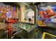 Fun game room featuring a foosball table and gaming area with themed decorations and modern lighting at 4429 Ganesha Loop, Kissimmee, FL 34746