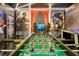 Spacious game room featuring a foosball table, comfortable seating, and themed wall decor at 4429 Ganesha Loop, Kissimmee, FL 34746