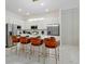 Modern kitchen with sleek white cabinets, stainless steel appliances, and island with seating at 4429 Ganesha Loop, Kissimmee, FL 34746