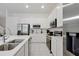 Bright kitchen featuring stainless steel appliances, white cabinets, and quartz countertops at 4429 Ganesha Loop, Kissimmee, FL 34746