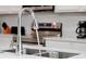 Close-up of a stainless steel kitchen sink with a modern faucet and quartz countertops at 4429 Ganesha Loop, Kissimmee, FL 34746