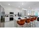 Bright kitchen features stainless steel appliances, white cabinets, and an island with seating at 4429 Ganesha Loop, Kissimmee, FL 34746