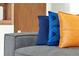 Comfortable living room sofa dressed with elegant throw pillows in blue and orange hues at 4429 Ganesha Loop, Kissimmee, FL 34746