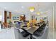 Open floorplan with dining area that leads to a living area with a mounted television at 4429 Ganesha Loop, Kissimmee, FL 34746
