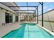 Spacious screened-in pool area with a spa and outdoor seating, offering a private oasis at 4429 Ganesha Loop, Kissimmee, FL 34746