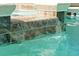 Close-up of the pool's water feature, showcasing the tile detail and clear, refreshing water at 4429 Ganesha Loop, Kissimmee, FL 34746