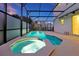 Screened pool and hot tub with patio area for entertaining guests at 4429 Ganesha Loop, Kissimmee, FL 34746