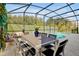 Screened-in lanai with outdoor dining furniture next to a private swimming pool at 4429 Ganesha Loop, Kissimmee, FL 34746