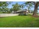 Spacious backyard with lush green grass, mature trees, and a privacy fence surrounding the property at 524 S Lakeview Ave, Winter Garden, FL 34787