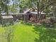 Spacious backyard featuring lush greenery, mature trees, and a wooden deck for outdoor enjoyment at 524 S Lakeview Ave, Winter Garden, FL 34787