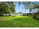 Large, grassy backyard enclosed by a white fence, perfect for outdoor activities and gardening at 524 S Lakeview Ave, Winter Garden, FL 34787