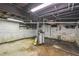Unfinished basement featuring exposed beams, white brick walls, and concrete floor at 524 S Lakeview Ave, Winter Garden, FL 34787