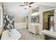 Bright bathroom with a white clawfoot tub, glass shower, and stylish tiled floors at 524 S Lakeview Ave, Winter Garden, FL 34787
