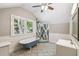 Bright bathroom with a blue clawfoot tub, glass shower, and stylish tiled floors at 524 S Lakeview Ave, Winter Garden, FL 34787