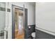 Well-lit bathroom featuring modern fixtures, wainscoting, and a nearby doorway at 524 S Lakeview Ave, Winter Garden, FL 34787