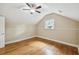 Cozy bedroom with hardwood floors, a ceiling fan, and a window offering natural light at 524 S Lakeview Ave, Winter Garden, FL 34787