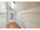 Walk-in closet with custom shelving and access to a well-appointed bathroom at 524 S Lakeview Ave, Winter Garden, FL 34787