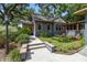 Quaint blue home with a red door, green landscaping, and a walkway at 524 S Lakeview Ave, Winter Garden, FL 34787