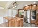 Open kitchen featuring stainless steel appliances, custom cabinetry, and an island at 524 S Lakeview Ave, Winter Garden, FL 34787