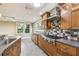 Stylish kitchen with modern appliances, custom cabinets, and a multi-colored tiled backsplash at 524 S Lakeview Ave, Winter Garden, FL 34787