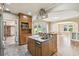 Stylish kitchen with stainless steel appliances, an island, and an open view to the living room at 524 S Lakeview Ave, Winter Garden, FL 34787