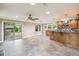 Open-concept room featuring tile flooring, backyard access, and an open kitchen at 524 S Lakeview Ave, Winter Garden, FL 34787