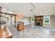 Open-concept living area with tile floors, a fireplace, and a kitchen with wood cabinets at 524 S Lakeview Ave, Winter Garden, FL 34787