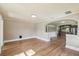 Open-concept living room featuring hardwood floors and an arched entryway to the kitchen at 524 S Lakeview Ave, Winter Garden, FL 34787