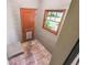 Functional mudroom with terra-cotta tile floor, and a backyard door at 524 S Lakeview Ave, Winter Garden, FL 34787