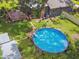 Aerial view of a backyard with an above-ground pool, deck, and well-maintained lawn at 524 S Lakeview Ave, Winter Garden, FL 34787