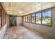 Bright sunroom with wood ceilings, terra-cotta floors, and multiple windows at 524 S Lakeview Ave, Winter Garden, FL 34787