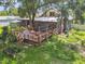 An aerial view of the backyard, showing a spacious deck, garden, and lush green grass at 524 S Lakeview Ave, Winter Garden, FL 34787