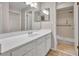 Bright bathroom featuring a vanity with white countertop, a large mirror and shower at 557 Hunter Cir, Kissimmee, FL 34758