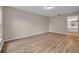 Large bedroom with wood-look floors, neutral paint and access to bathroom at 557 Hunter Cir, Kissimmee, FL 34758