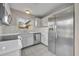 Renovated kitchen featuring stainless steel appliances, tile floors and white cabinets at 557 Hunter Cir, Kissimmee, FL 34758