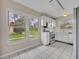 Bright kitchen with white cabinets, stainless steel appliances, and a large window at 557 Hunter Cir, Kissimmee, FL 34758