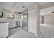 Modern kitchen with stainless steel refrigerator and view into the living area at 557 Hunter Cir, Kissimmee, FL 34758