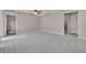Expansive living room featuring white tile flooring, neutral walls, and a ceiling fan at 557 Hunter Cir, Kissimmee, FL 34758